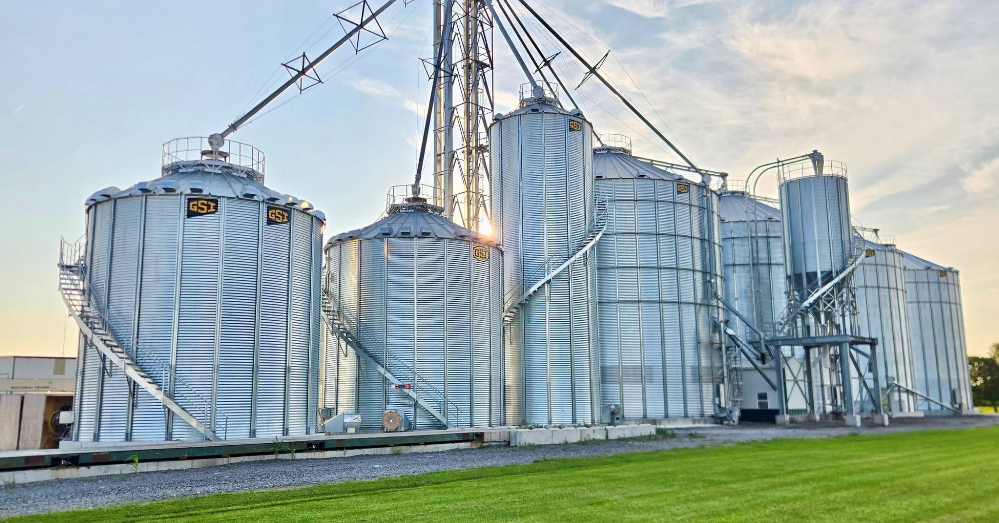 Grain storage bins and handling equipment at a farm facility.